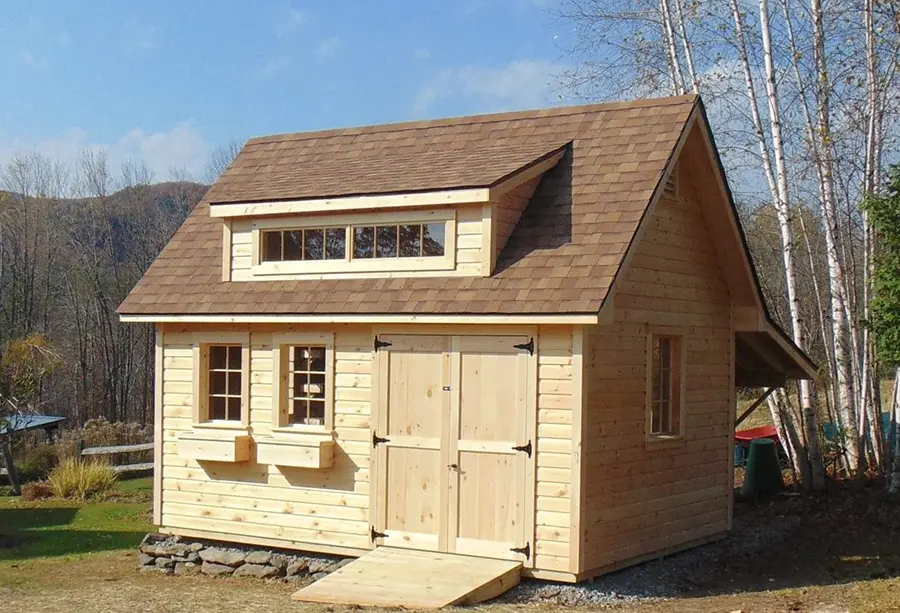 a custom shed with roof dormer and flower boxes built in Huntington Vermont